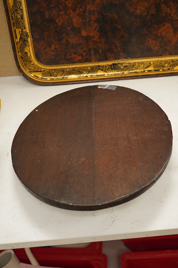 An early 20th century oval carved oak panel depicting a dog before a kennel, 46cm high. Condition - good